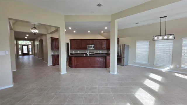a view of a kitchen with a sink and a refrigerator