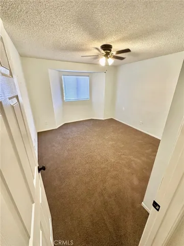 a view of a big room with wooden floor and entryway