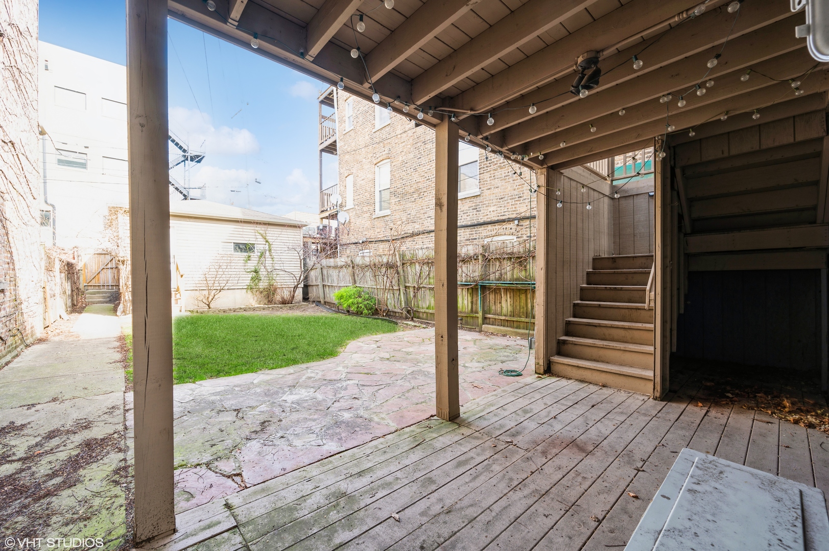 2116 West Lyndale Street, Unit 1 Chicago, IL 60647 - Photo 11 of 16 a view of a porch with wooden floor and wooden fence