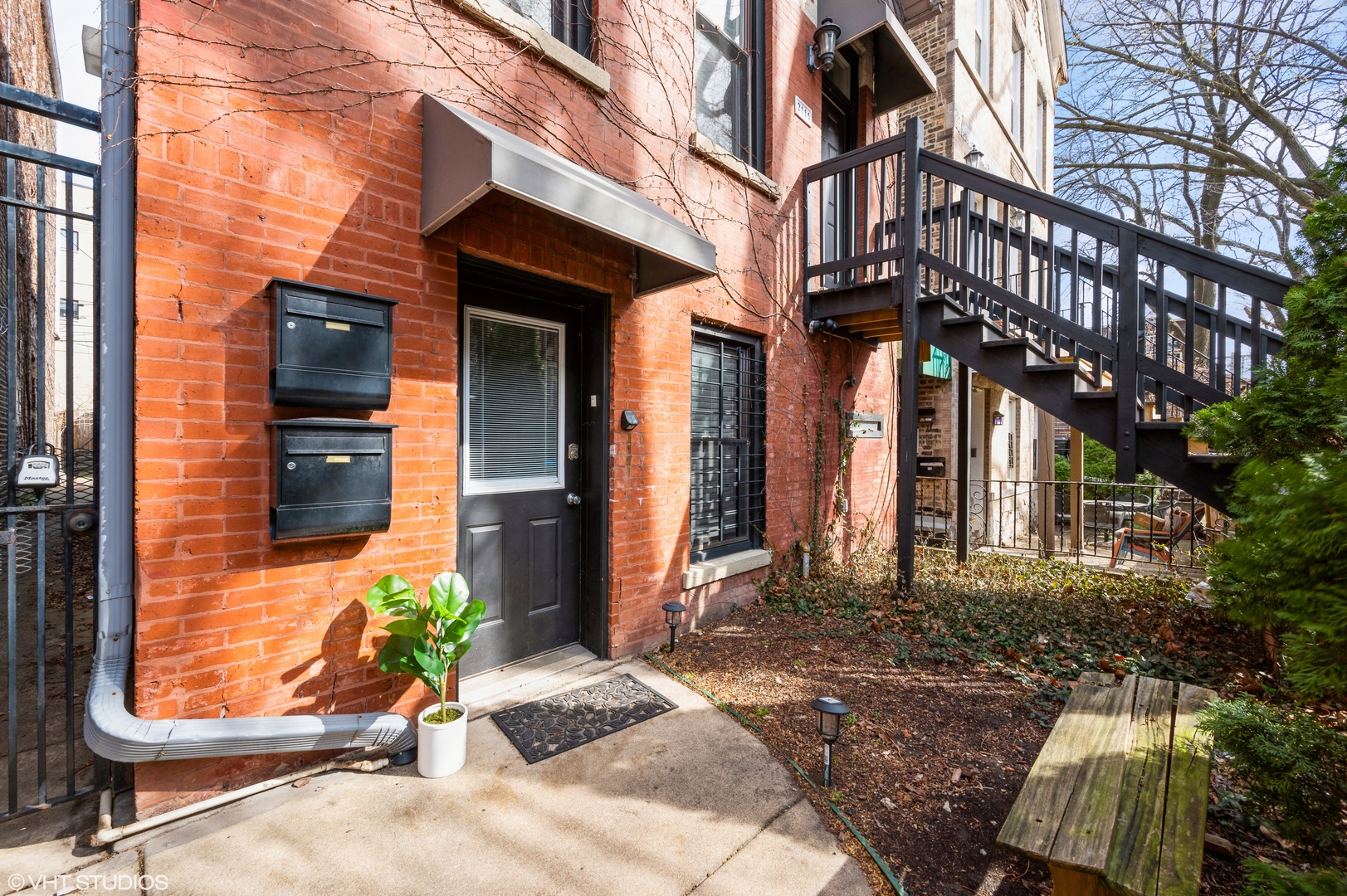 2116 West Lyndale Street, Unit 1 Chicago, IL 60647 - Photo 2 of 16 a view of a brick house with large windows and plants