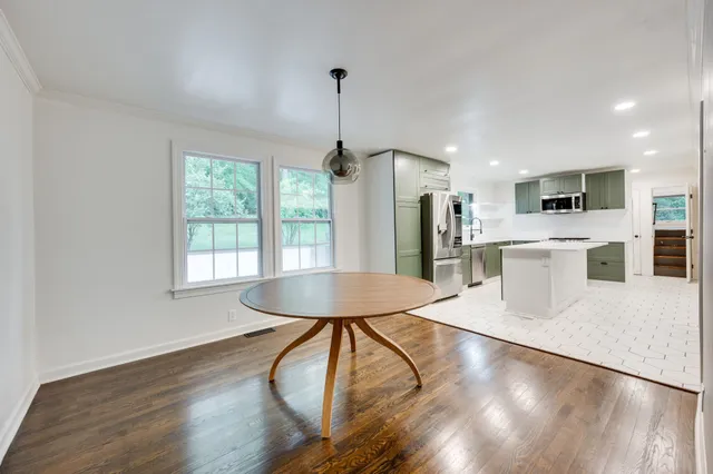 a kitchen with stainless steel appliances kitchen island hardwood floor sink stove and wooden floor