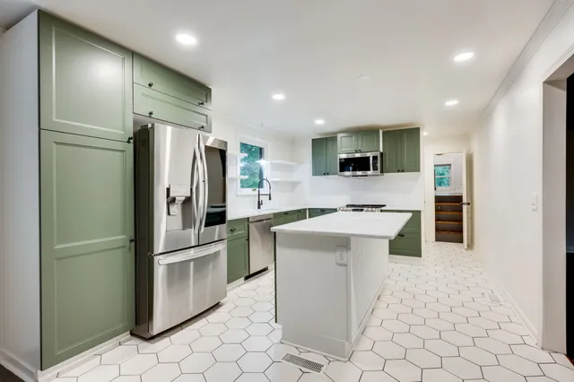 a kitchen with cabinets and stainless steel appliances