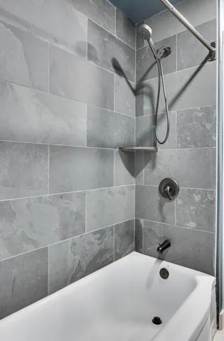 a bathroom with a tub and a shower