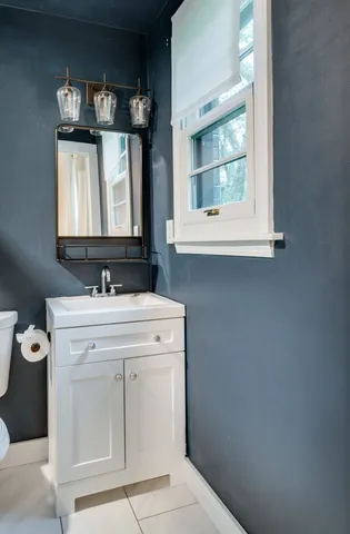 a bathroom with a sink vanity and mirror