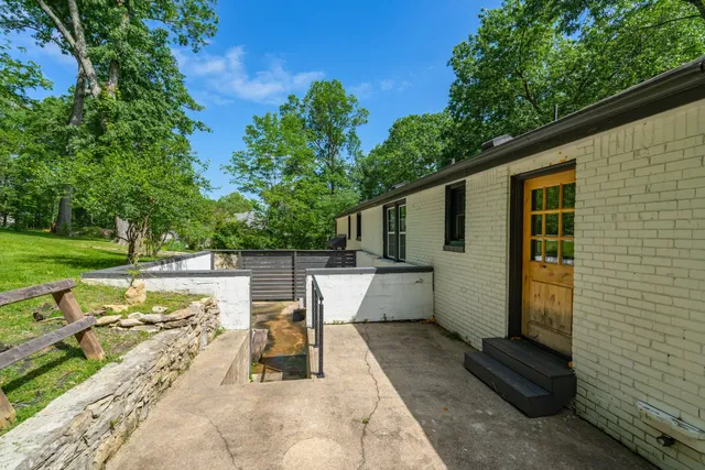 a view of a patio with a table and chairs