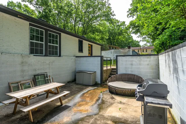 a backyard of a house with fire pit and barbeque oven