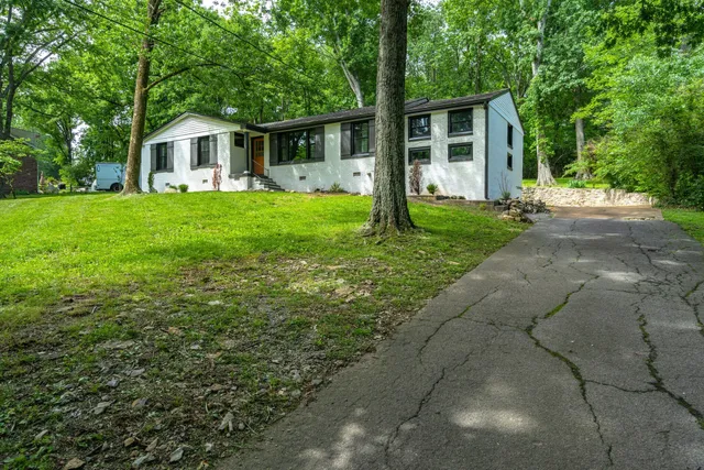 a front view of house with yard and green space