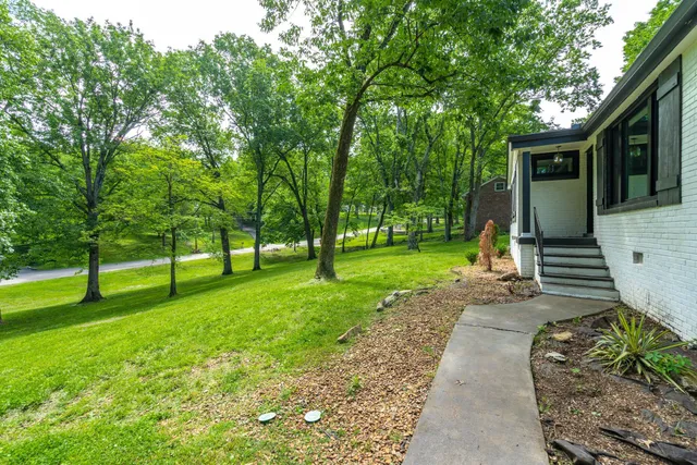 a view of a house with a backyard