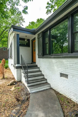 a view of house with wooden floor and outdoor seating