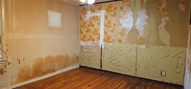 a view of a room with wooden floor and bathroom