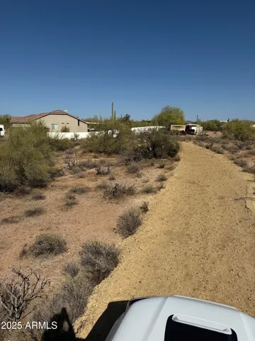 a view of a large building with mountains in the background