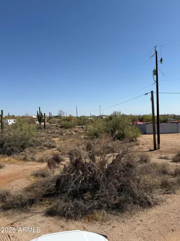 a view of a dry yard with mountains in the background