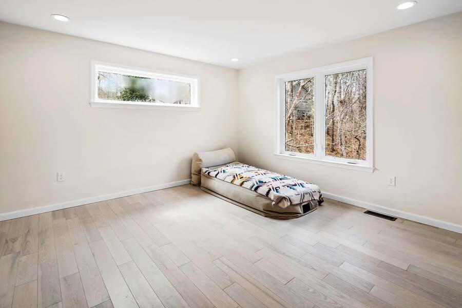135 Old Truro Road Wellfleet, MA 02667 - Photo 20 of 38 a bedroom with a bed and a painting on the wall