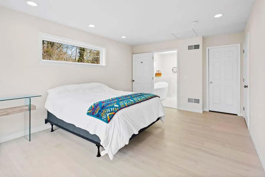 135 Old Truro Road Wellfleet, MA 02667 - Photo 24 of 38 a bedroom with a bed and painting on the wall