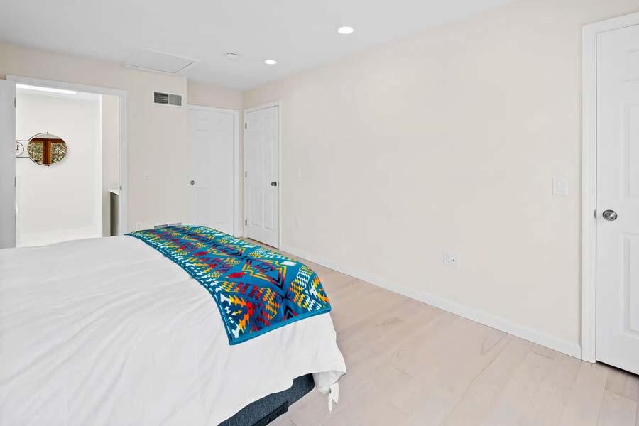 135 Old Truro Road Wellfleet, MA 02667 - Photo 25 of 38 a bedroom with a bed and a painting on the wall