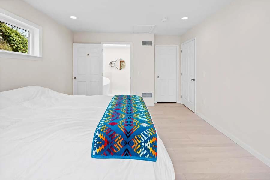 135 Old Truro Road Wellfleet, MA 02667 - Photo 26 of 38 a bedroom with a bed and a painting on the wall