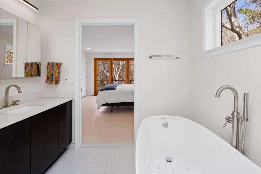 135 Old Truro Road Wellfleet, MA 02667 - Photo 29 of 38 a en suite bathroom with a tub sink and mirror