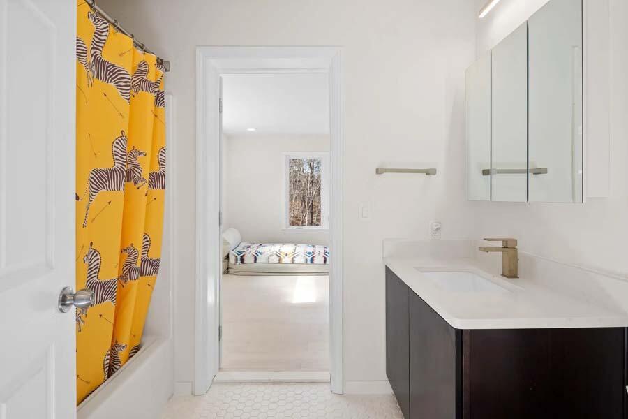 135 Old Truro Road Wellfleet, MA 02667 - Photo 30 of 38 a bathroom with a sink a mirror and a shower