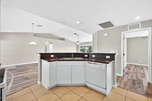 a kitchen with stainless steel appliances a sink and cabinets