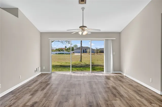 wooden floor in an empty room with a window