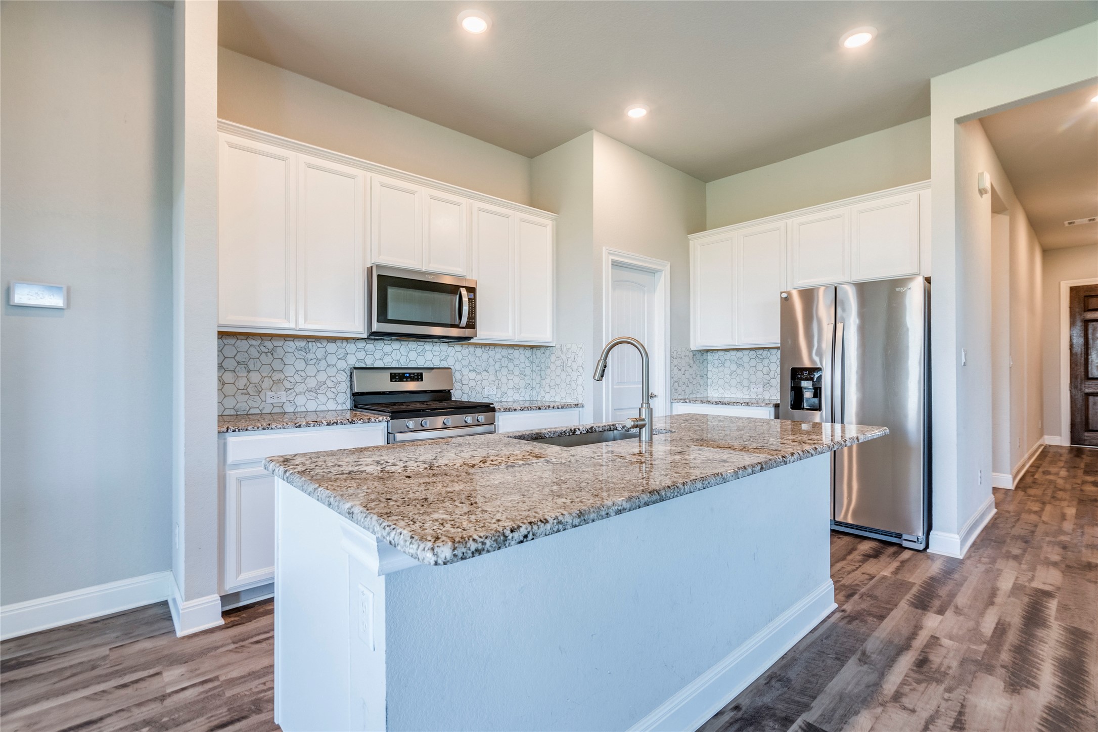 130 Sierra Blanca Road Dripping Springs, TX 78620 - Photo 10 of 24 a kitchen with granite countertop a refrigerator and a sink