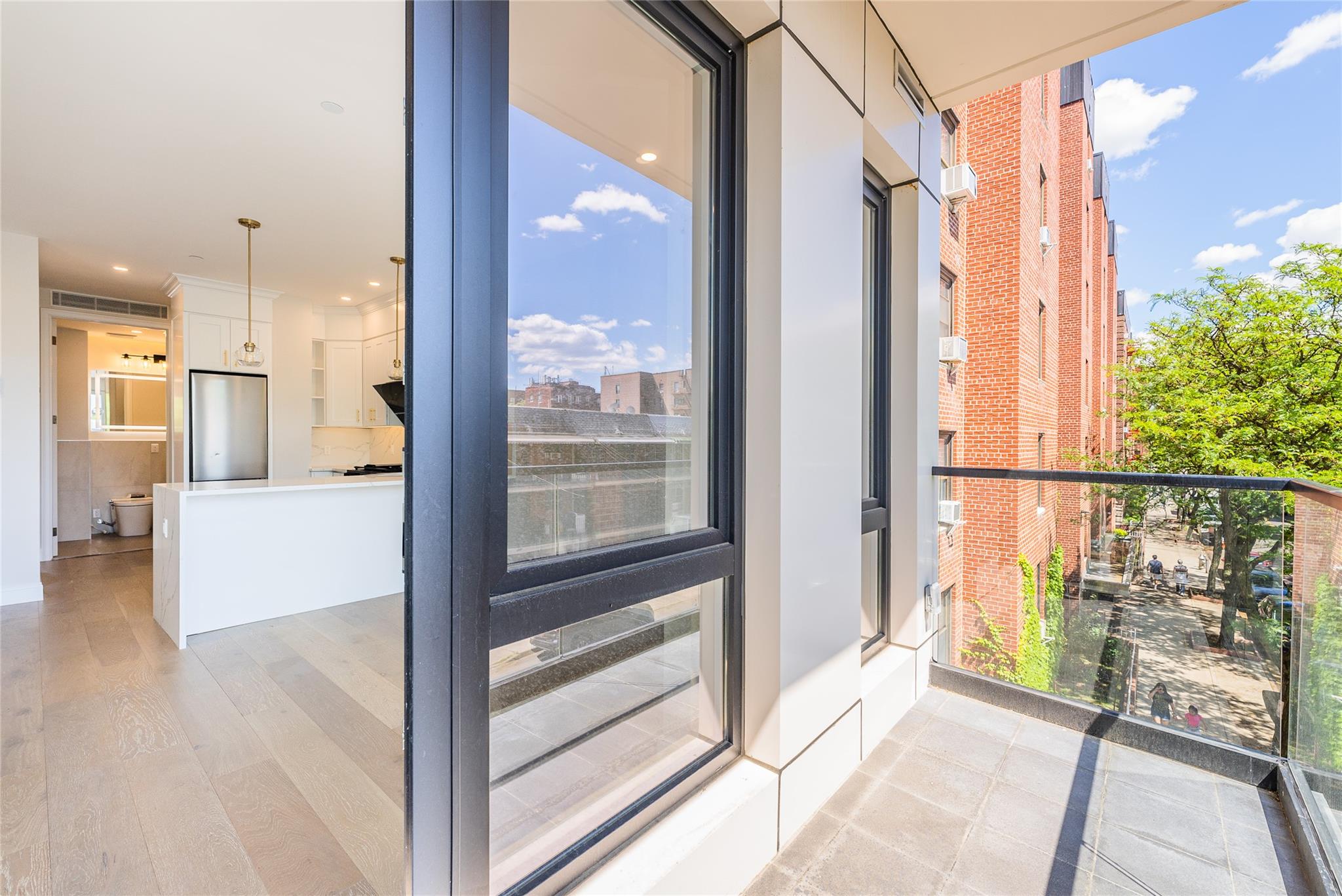 42-09 Hampton Street, Unit 4B Queens, NY 11373 - Photo 12 of 16 a view of an entryway with wooden floor and a floor to ceiling window