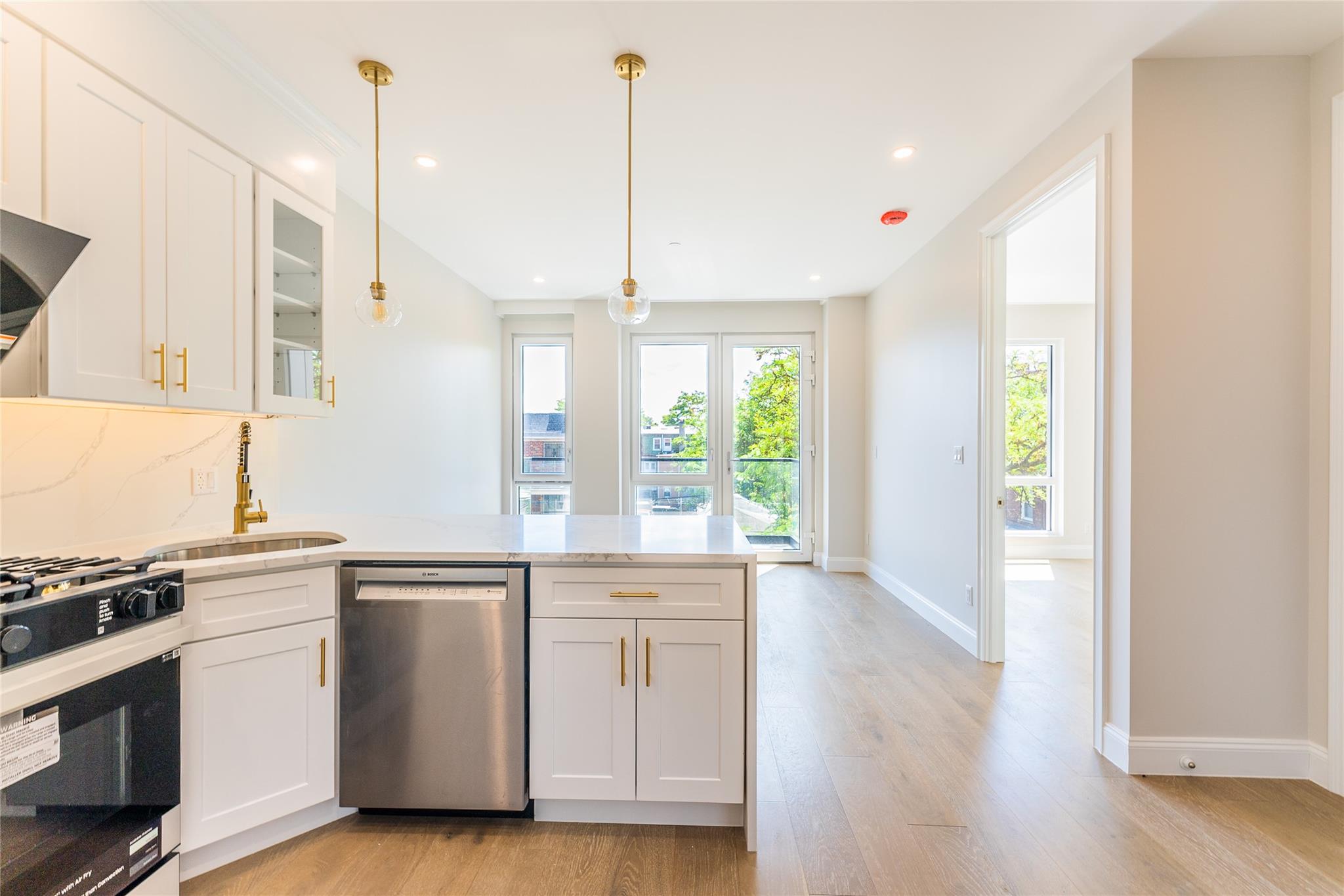 42-09 Hampton Street, Unit 4B Queens, NY 11373 - Photo 9 of 16 a kitchen with a sink and white cabinets