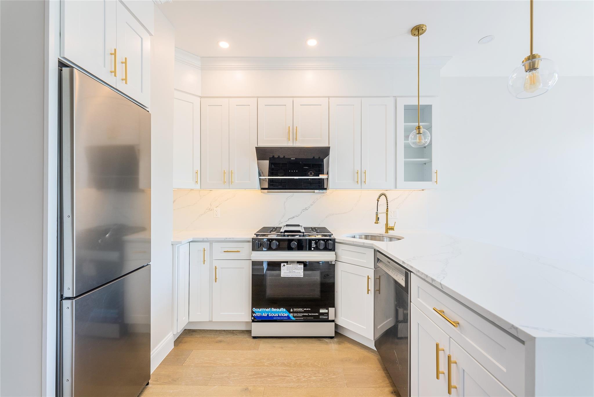 42-09 Hampton Street, Unit 4B Queens, NY 11373 - Photo 10 of 16 a kitchen with a stove and a refrigerator
