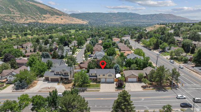 1726 Wasatch Boulevard Sandy, UT 84092 - Photo 34 of 38 Two-story property featuring an attached three car garage, light-toned siding, and mature landscaping