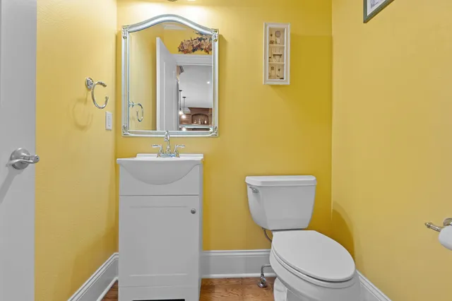 a bathroom with a toilet sink and mirror