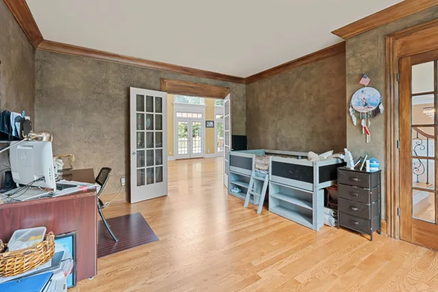 a living room with furniture a piano and a flat screen tv