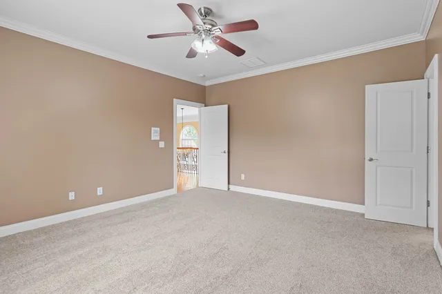 a view of an empty room with a fan