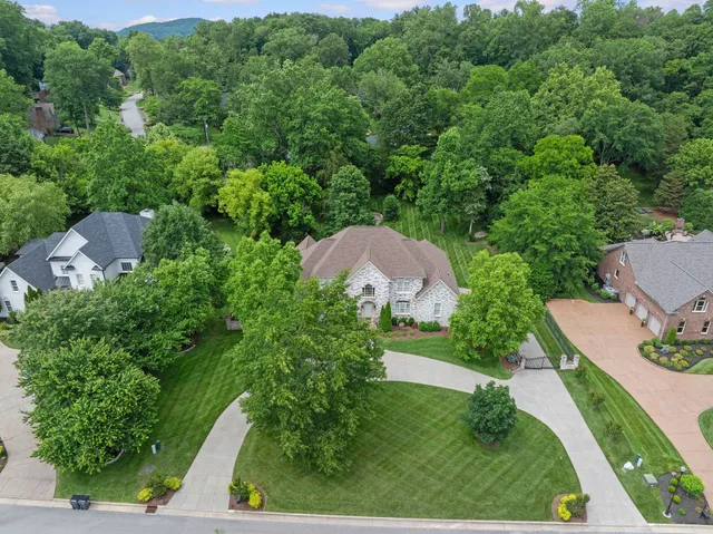 an aerial view of a house with yard and outdoor seating