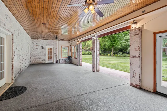 a view of a porch with furniture and floor to ceiling window