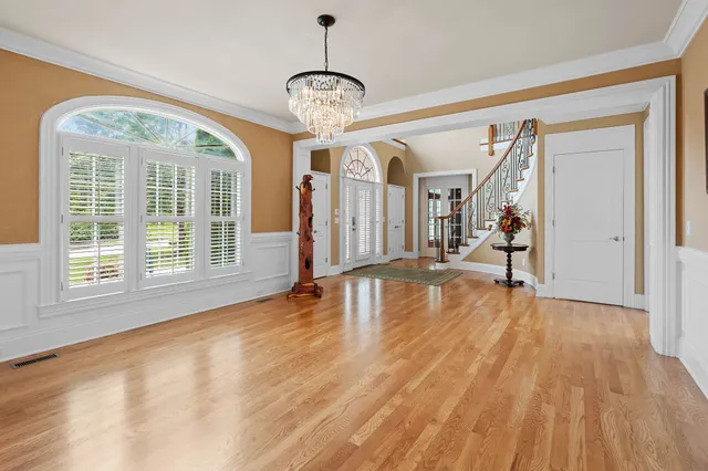 a view of a livingroom with wooden floor and a large window