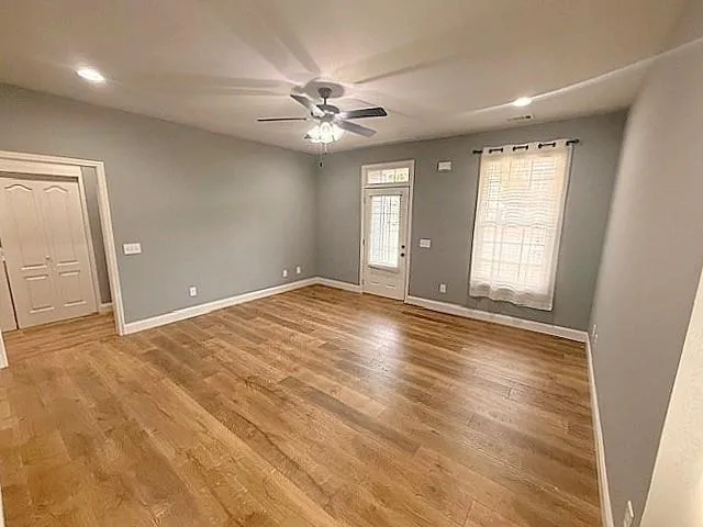 wooden floor in an empty room with a window