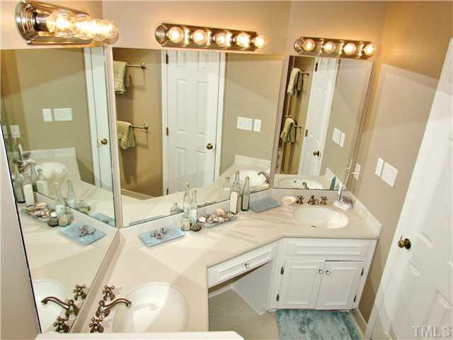 7316 Glendower Road Raleigh, NC 27613 - Photo 21 of 25 a bathroom with a sink double vanity and a mirror