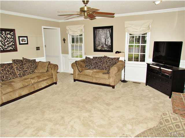 7316 Glendower Road Raleigh, NC 27613 - Photo 3 of 25 a living room with furniture window and a flat screen television