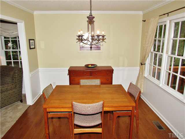 7316 Glendower Road Raleigh, NC 27613 - Photo 5 of 25 a dining room with a table and chandelier