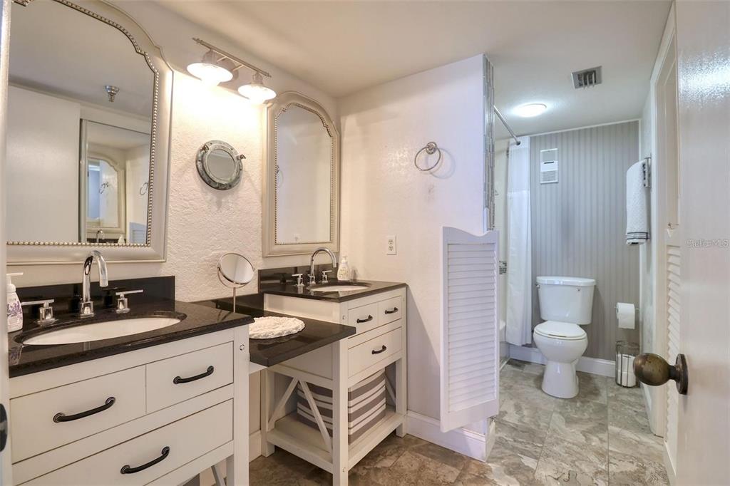 5915 Sea Ranch Drive, Unit 211 Hudson, FL 34667 - Photo 12 of 26 a spacious bathroom with a double vanity sink a toilet and a mirror