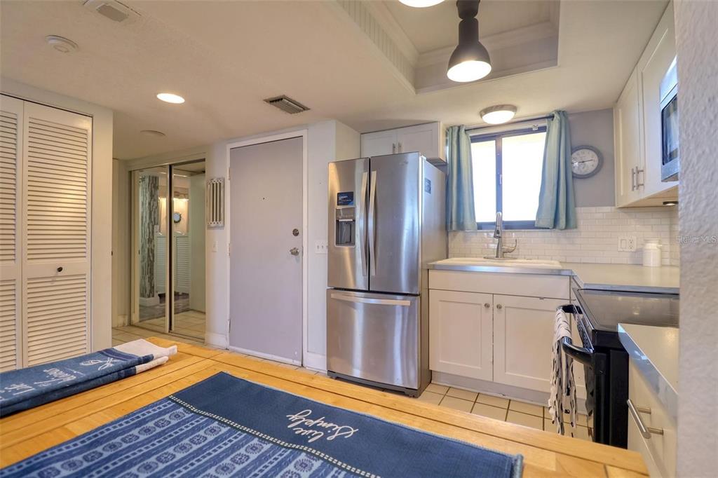 5915 Sea Ranch Drive, Unit 211 Hudson, FL 34667 - Photo 4 of 26 a kitchen with a refrigerator sink and cabinets