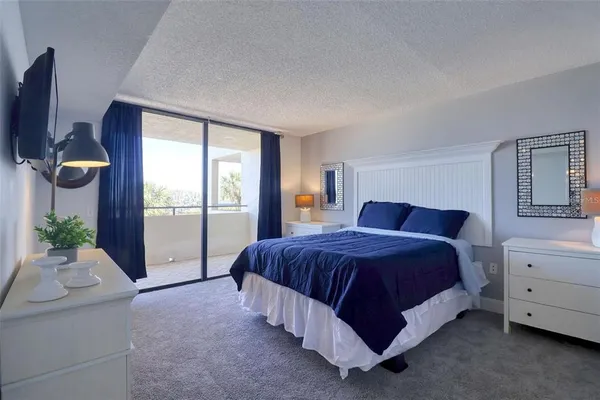 a spacious bedroom with a bed and window