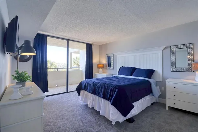 a spacious bedroom with a bed and window