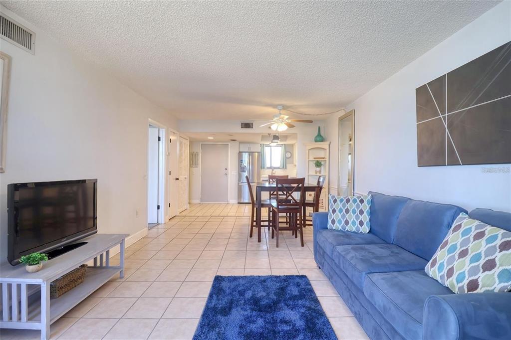 5915 Sea Ranch Drive, Unit 211 Hudson, FL 34667 - Photo 8 of 26 a living room with furniture and a flat screen tv