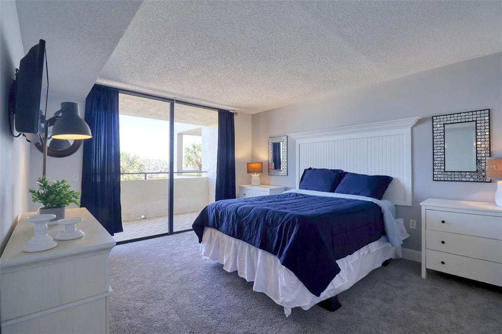 5915 Sea Ranch Drive, Unit 211 Hudson, FL 34667 - Photo 9 of 26 a spacious bedroom with a bed and window