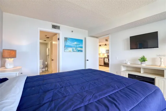 a bedroom with a bed and a flat screen tv