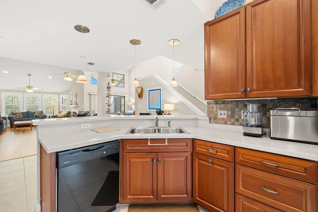 a kitchen with granite countertop a sink stainless steel appliances and cabinets