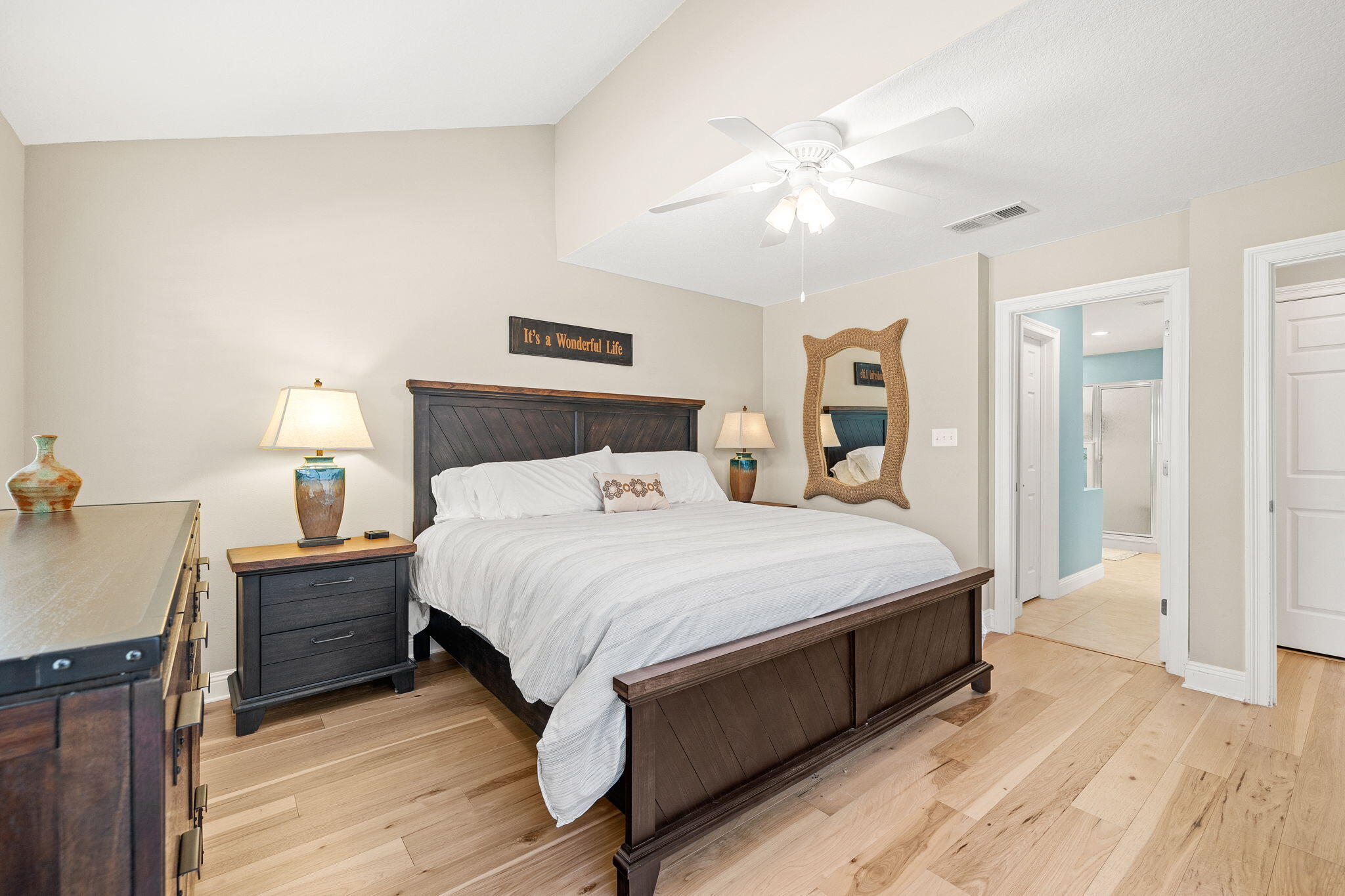 100 Gleneagles Drive Niceville, FL 32578 - Photo 22 of 60 a bedroom with a bed and a chandelier