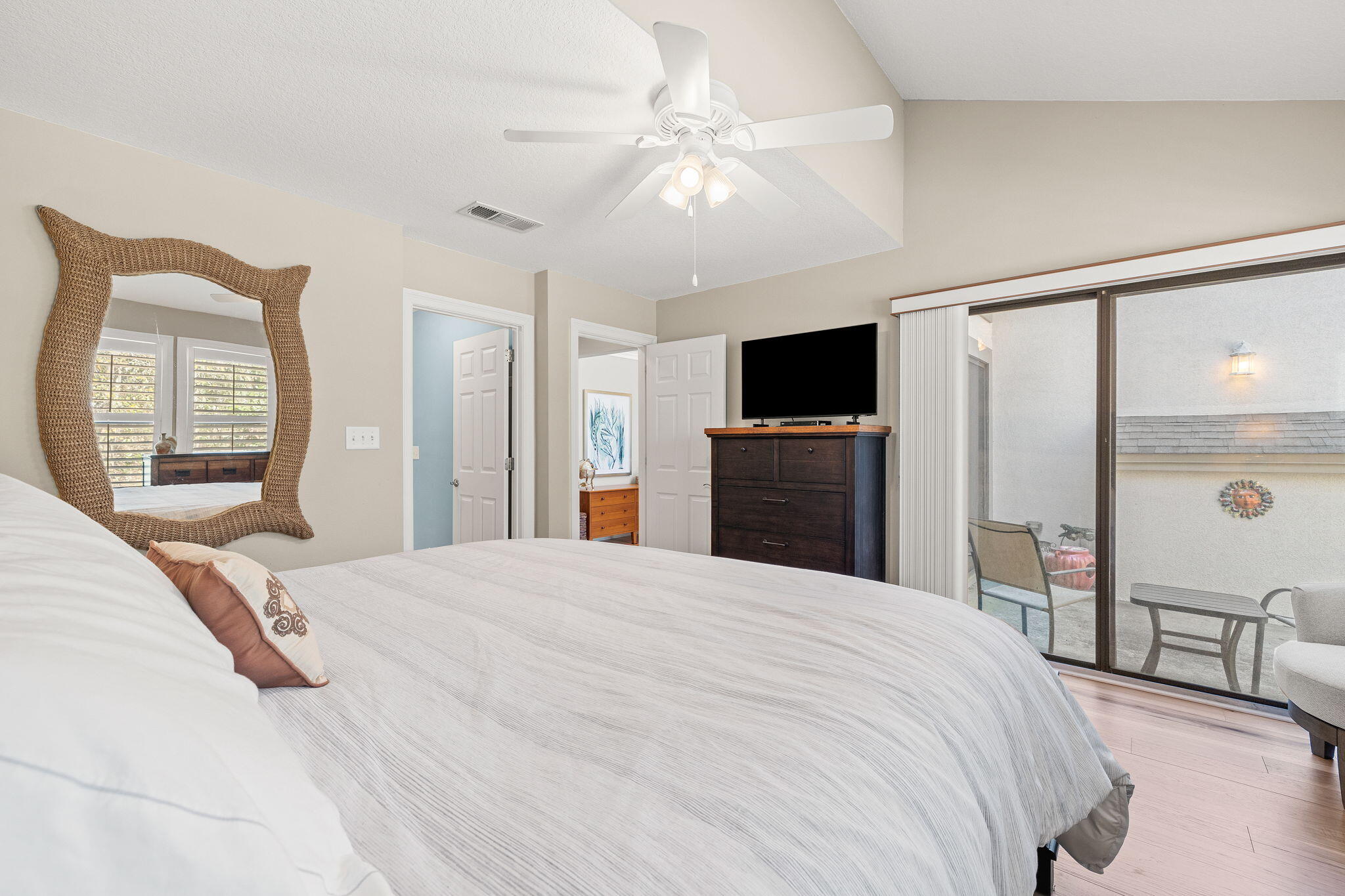 100 Gleneagles Drive Niceville, FL 32578 - Photo 23 of 60 a spacious bedroom with a large bed a flat tv screen and large closet
