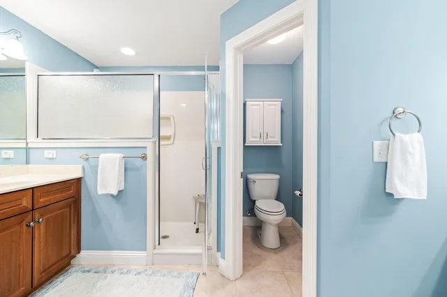 a bathroom with a tub a sink and mirror